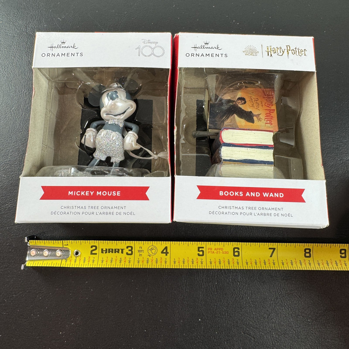 Set of 2 Hallmark ornaments featuring Disney 100 silver glitter Mickey Mouse and Harry Potter Hogwarts books in original boxes