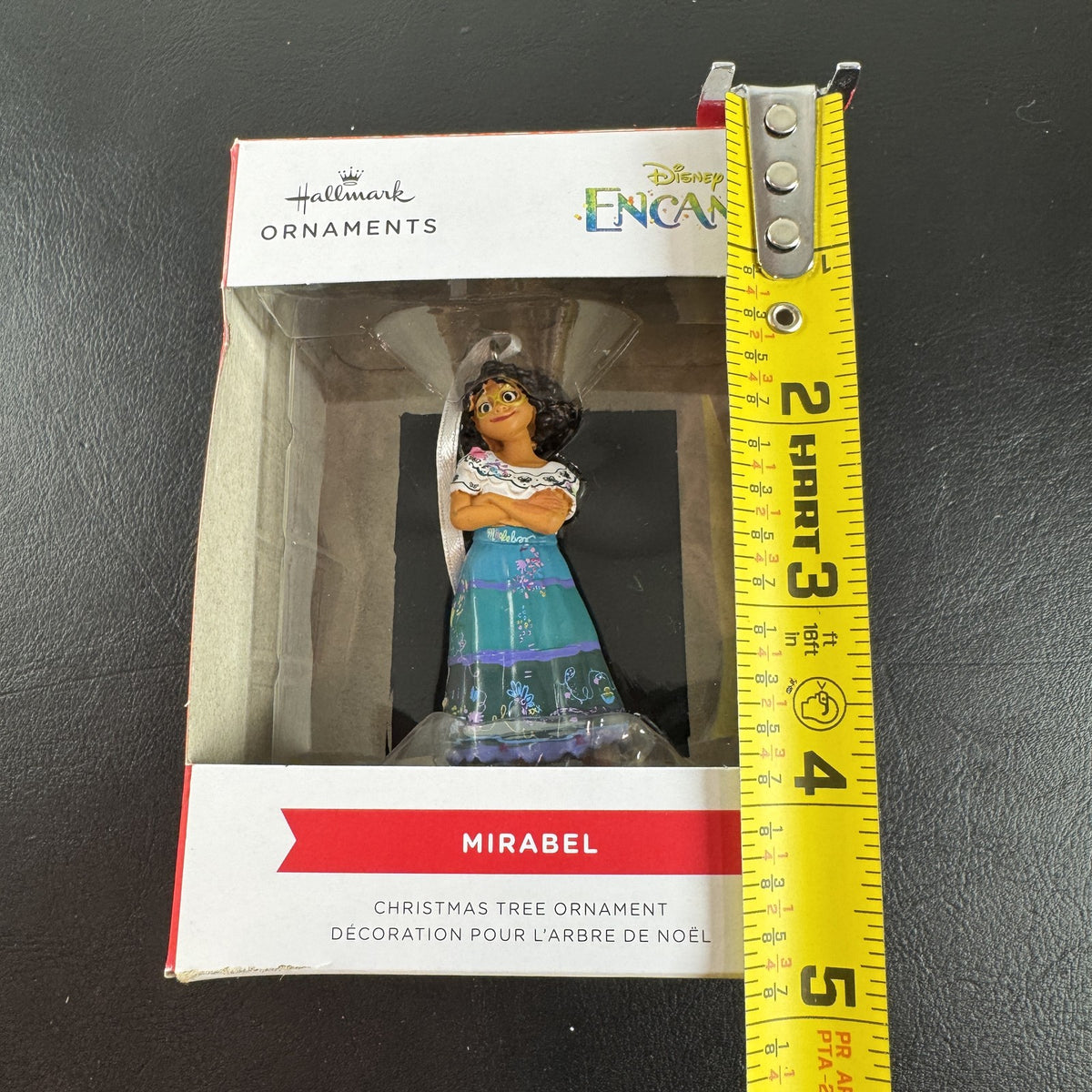Hallmark Disney Encanto Mirabel Madrigal Christmas ornament in original box showing green glasses and floral skirt