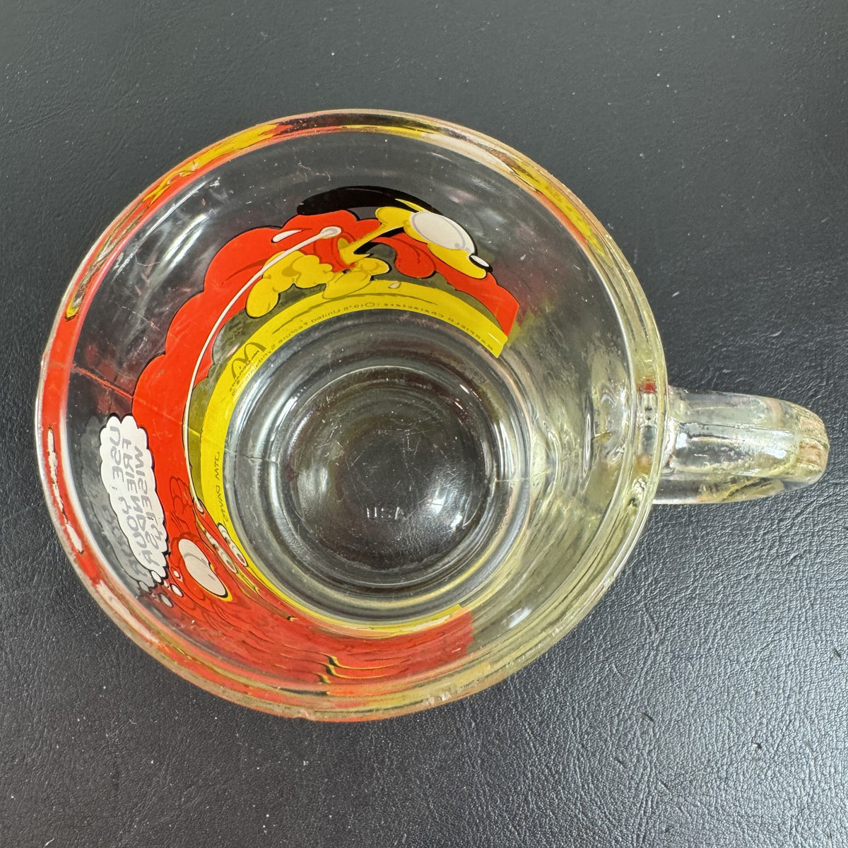 Vintage 1978 McDonald's clear glass mug featuring Garfield on a skateboard pulled by Odie.