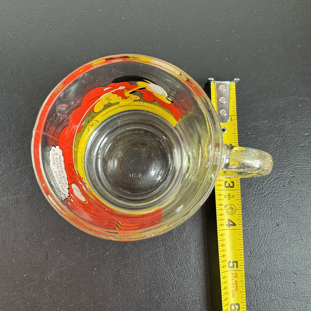 Vintage 1978 McDonald's clear glass mug featuring Garfield on a skateboard pulled by Odie.