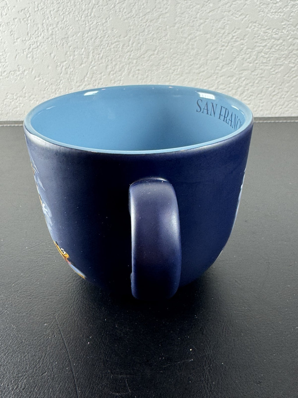 Disney navy blue ceramic mug featuring Mickey Mouse and friends riding a San Francisco cable car