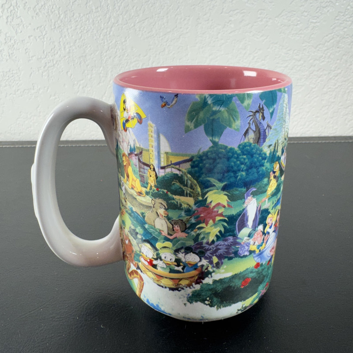 Disneyland park map ceramic coffee mug featuring Mickey Mouse and a pink interior glaze.