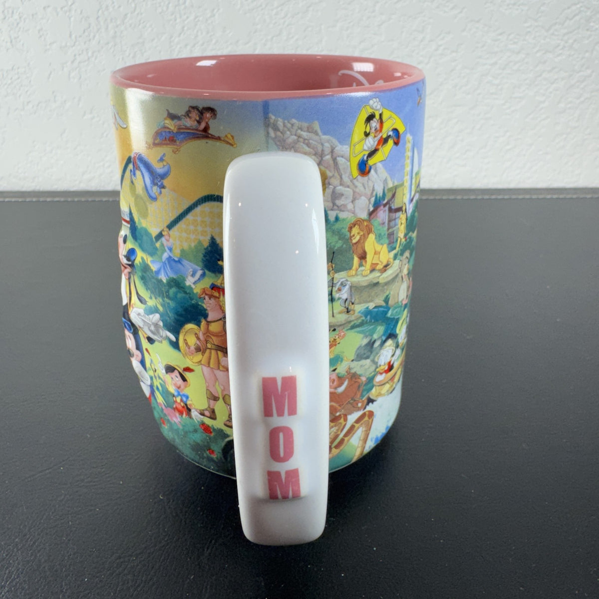 Disneyland park map ceramic coffee mug featuring Mickey Mouse and a pink interior glaze.
