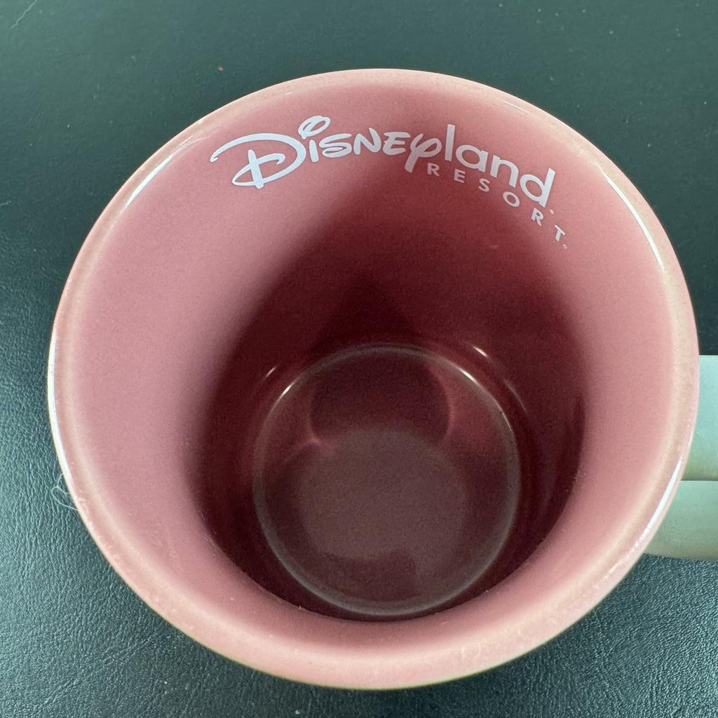 Disneyland park map ceramic coffee mug featuring Mickey Mouse and a pink interior glaze.