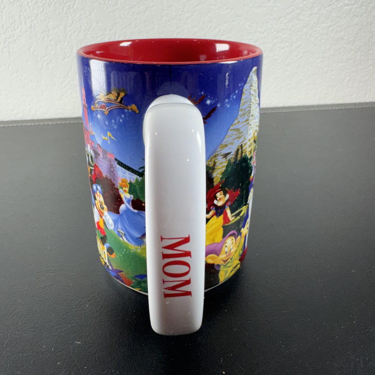 Disneyland Resort ceramic coffee mug with wrap around Disney character collage and bright red interior finish