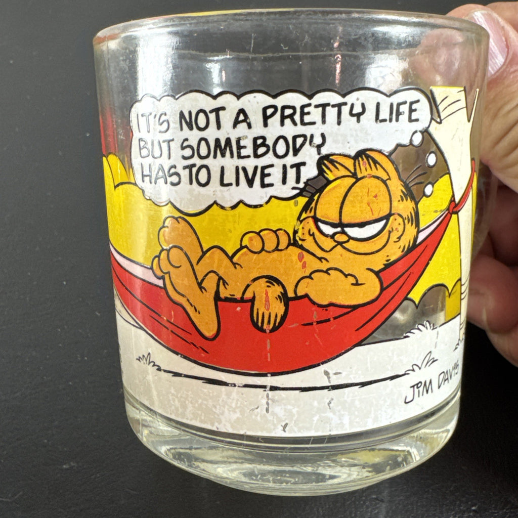Set of three vintage cartoon promo glasses featuring McDonald's Garfield mug and Welch's jelly jars.
