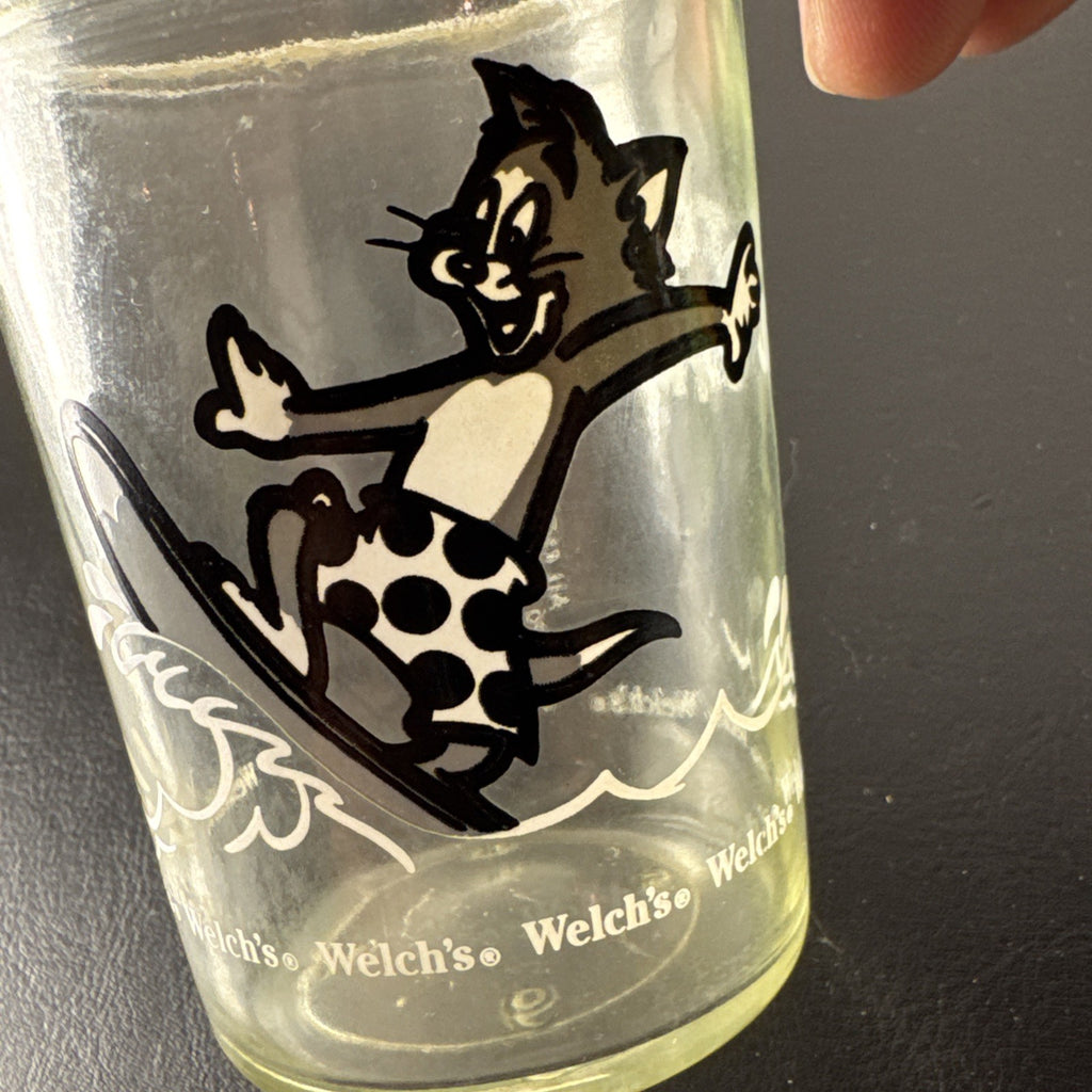 Set of three vintage cartoon promo glasses featuring McDonald's Garfield mug and Welch's jelly jars.