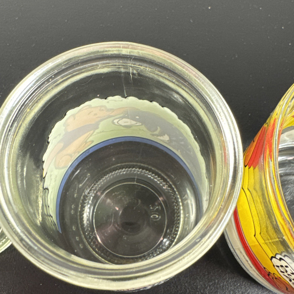 Set of three vintage cartoon promo glasses featuring McDonald's Garfield mug and Welch's jelly jars.