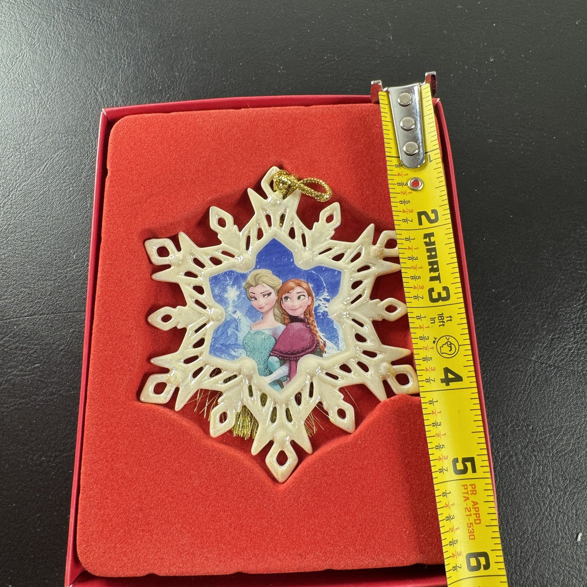 Lenox Disney Showcase Frozen Elsa and Anna fine porcelain snowflake Christmas ornament with gold tassel.