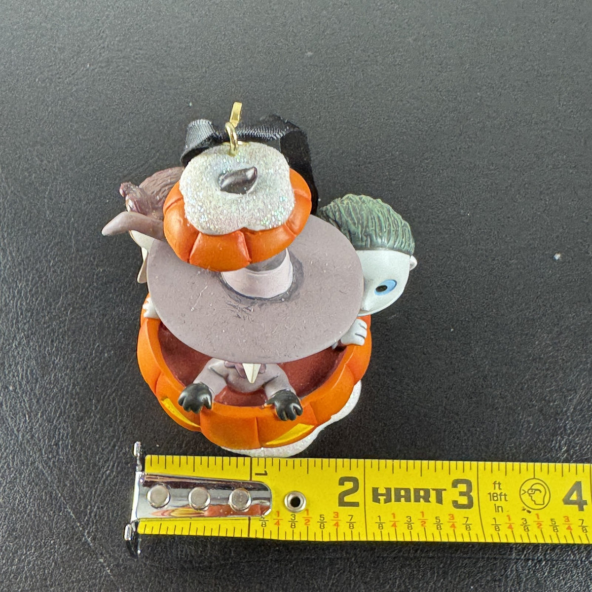 Disney Nightmare Before Christmas Lock, Shock, and Barrel resin pumpkin ornament with glitter base.