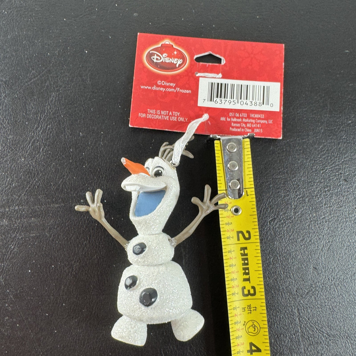 Hallmark 2015 Disney Frozen Olaf glitter resin Christmas tree ornament with original hang tag attached.