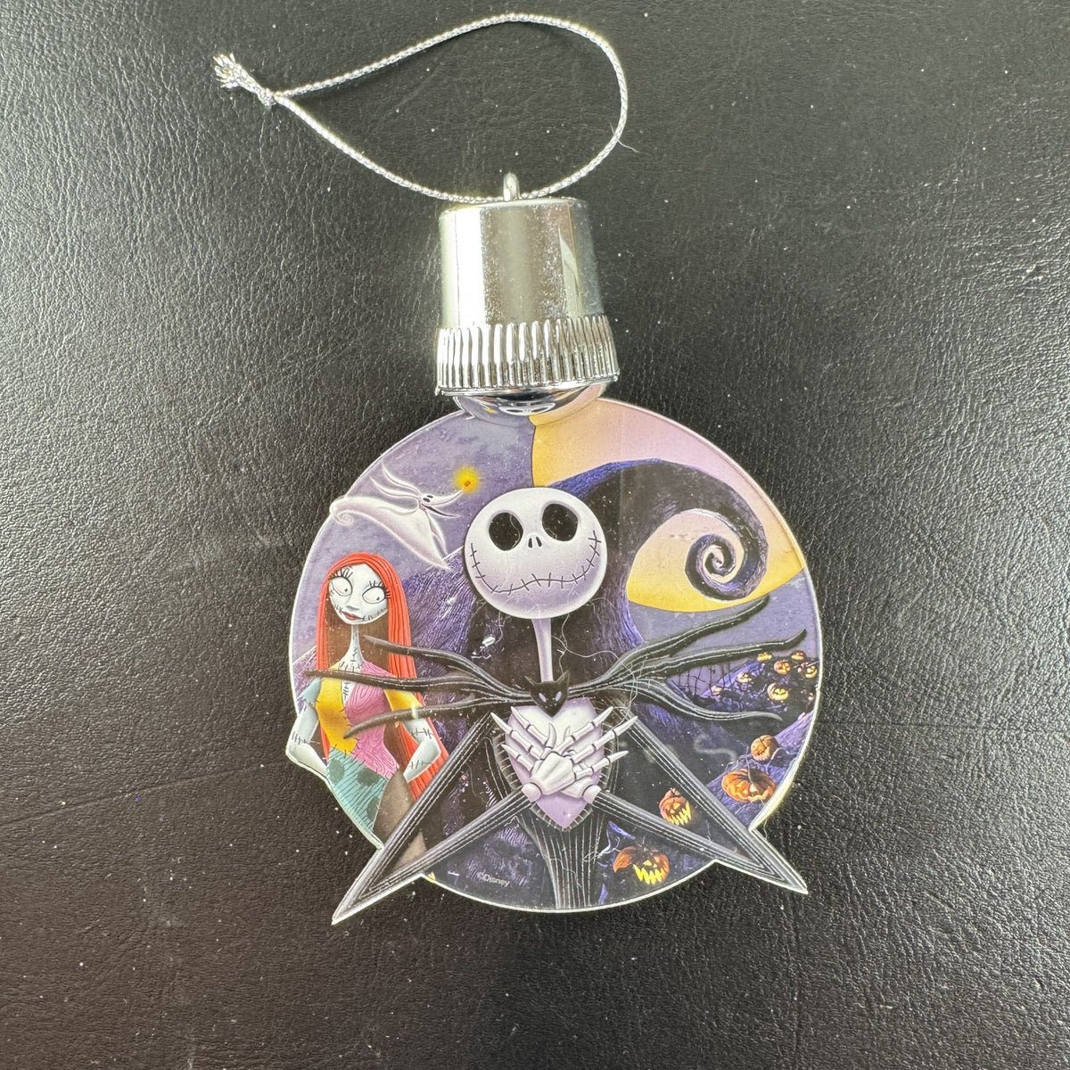Disney Nightmare Before Christmas LED light-up clear acrylic disc ornament featuring Jack Skellington and Sally.