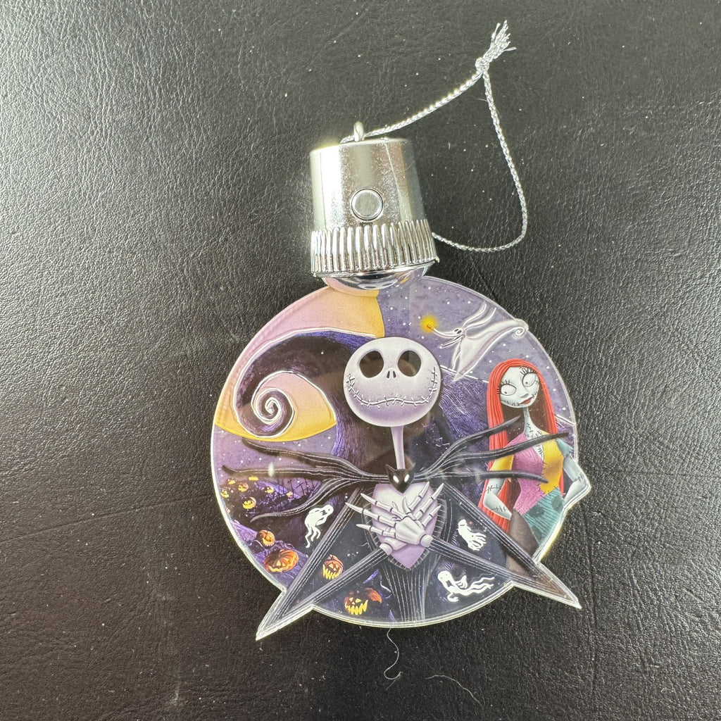 Disney Nightmare Before Christmas LED light-up clear acrylic disc ornament featuring Jack Skellington and Sally.