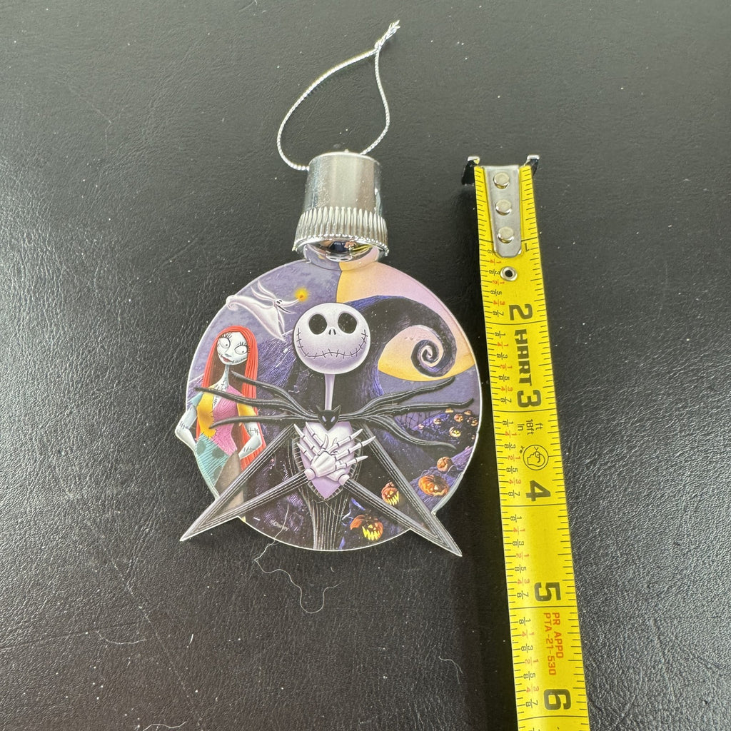 Disney Nightmare Before Christmas LED light-up clear acrylic disc ornament featuring Jack Skellington and Sally.