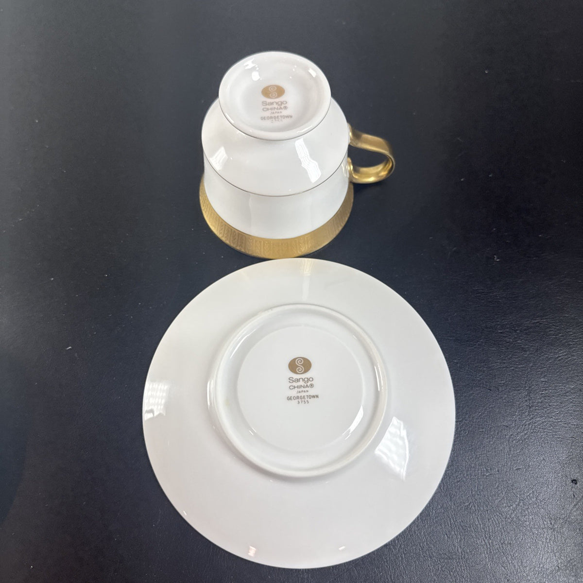 Sango Georgetown fine china teacup and saucer set of 2 featuring white porcelain with gold encrusted border trim.