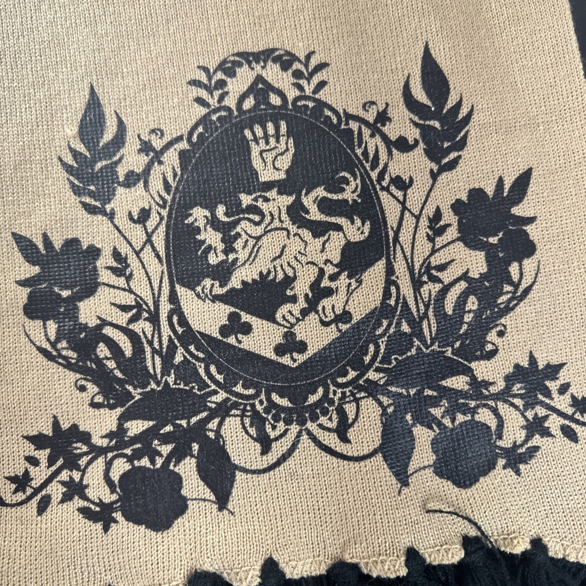 Tan knit Twilight Saga New Moon promo scarf featuring the Cullen family crest and black fringe tassels.