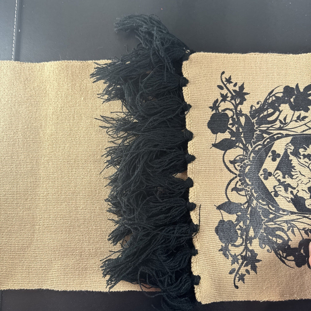 Tan knit Twilight Saga New Moon promo scarf featuring the Cullen family crest and black fringe tassels.