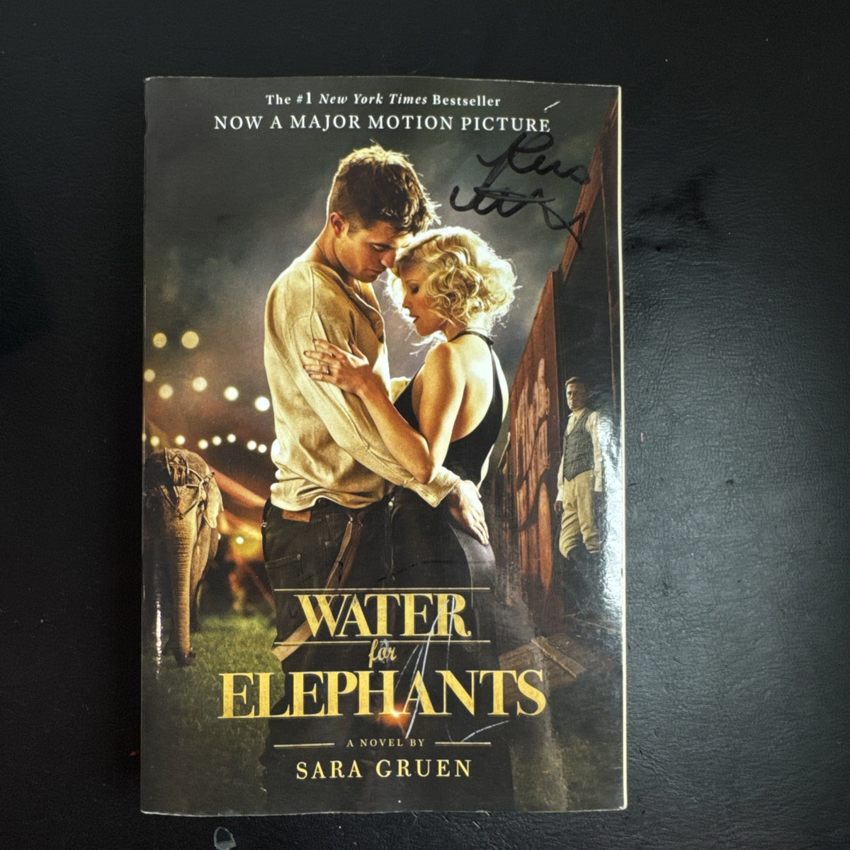 Front cover of Water for Elephants movie tie-in paperback by Sara Gruen with unverified Robert Pattinson signature.