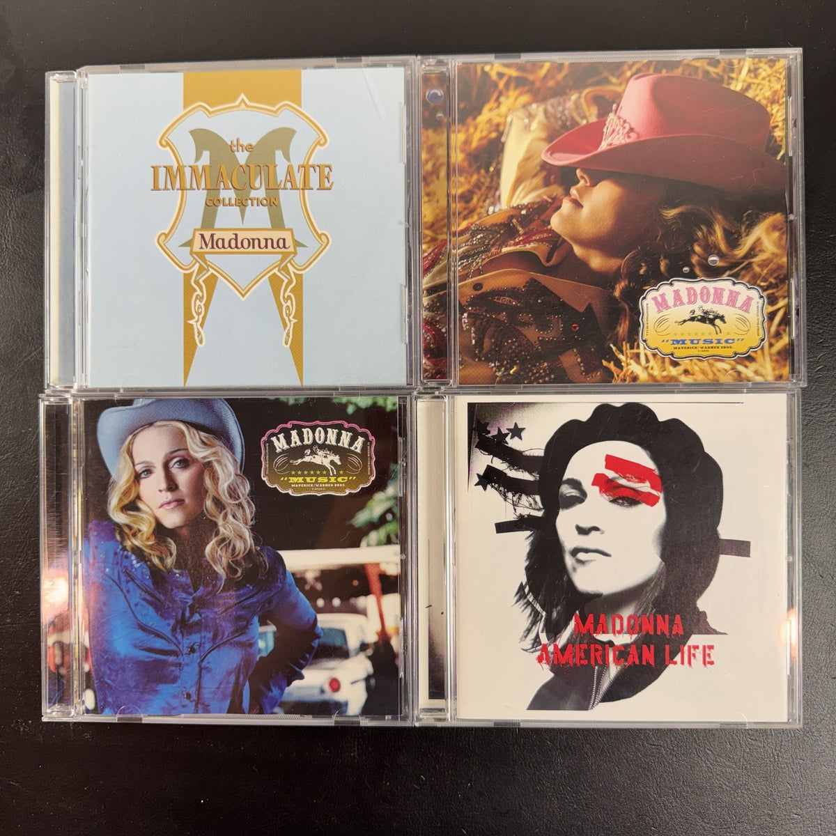 Lot of 4 Madonna CDs including The Immaculate Collection, American Life, and two Music album cover variants.