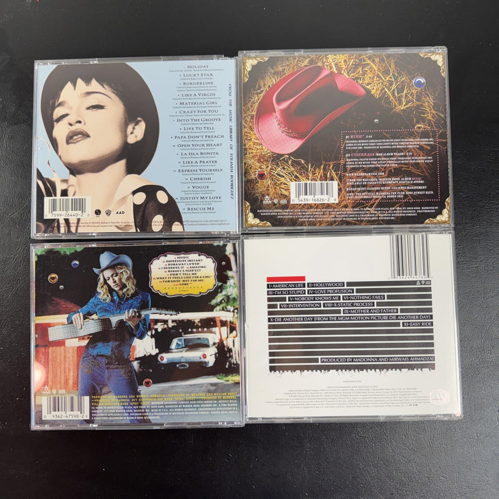 Lot of 4 Madonna CDs including The Immaculate Collection, American Life, and two Music album cover variants.