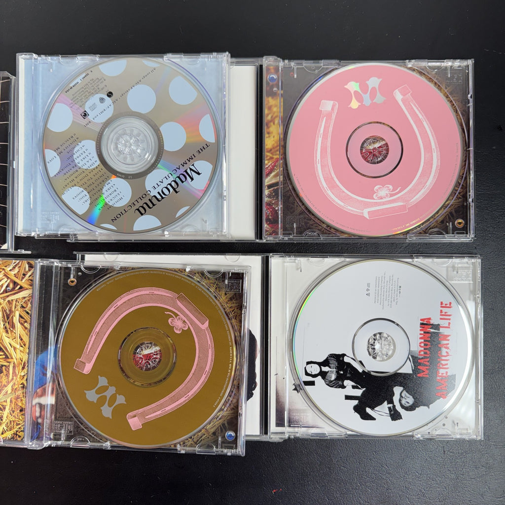Lot of 4 Madonna CDs including The Immaculate Collection, American Life, and two Music album cover variants.