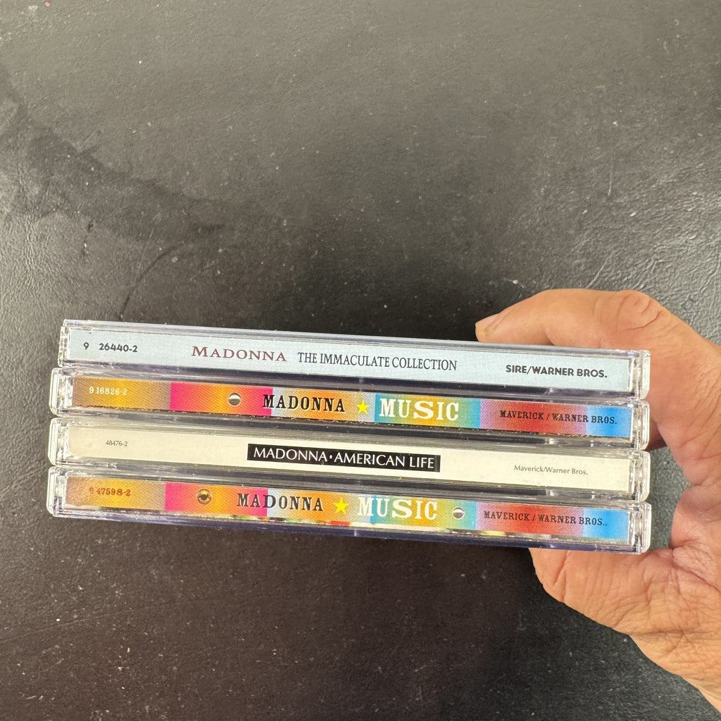 Lot of 4 Madonna CDs including The Immaculate Collection, American Life, and two Music album cover variants.