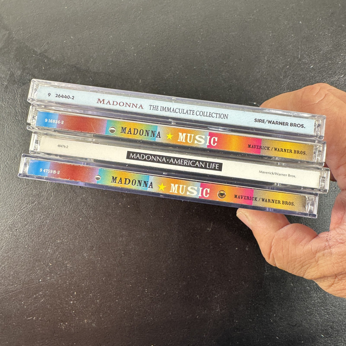 Lot of 4 Madonna CDs including The Immaculate Collection, American Life, and two Music album cover variants.