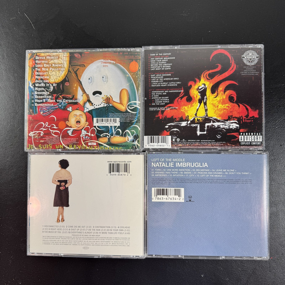 4 CD album lot featuring Beck Odelay, Green Day 21st Century Breakdown, Natalie Imbruglia, and Kelly Osbourne CDs