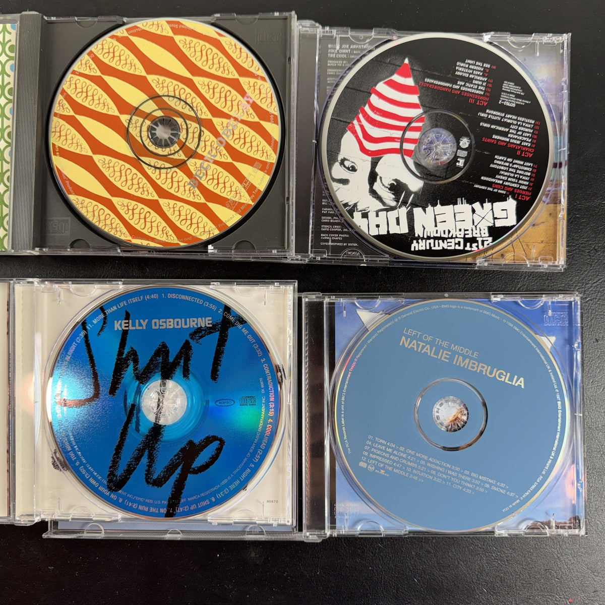 4 CD album lot featuring Beck Odelay, Green Day 21st Century Breakdown, Natalie Imbruglia, and Kelly Osbourne CDs