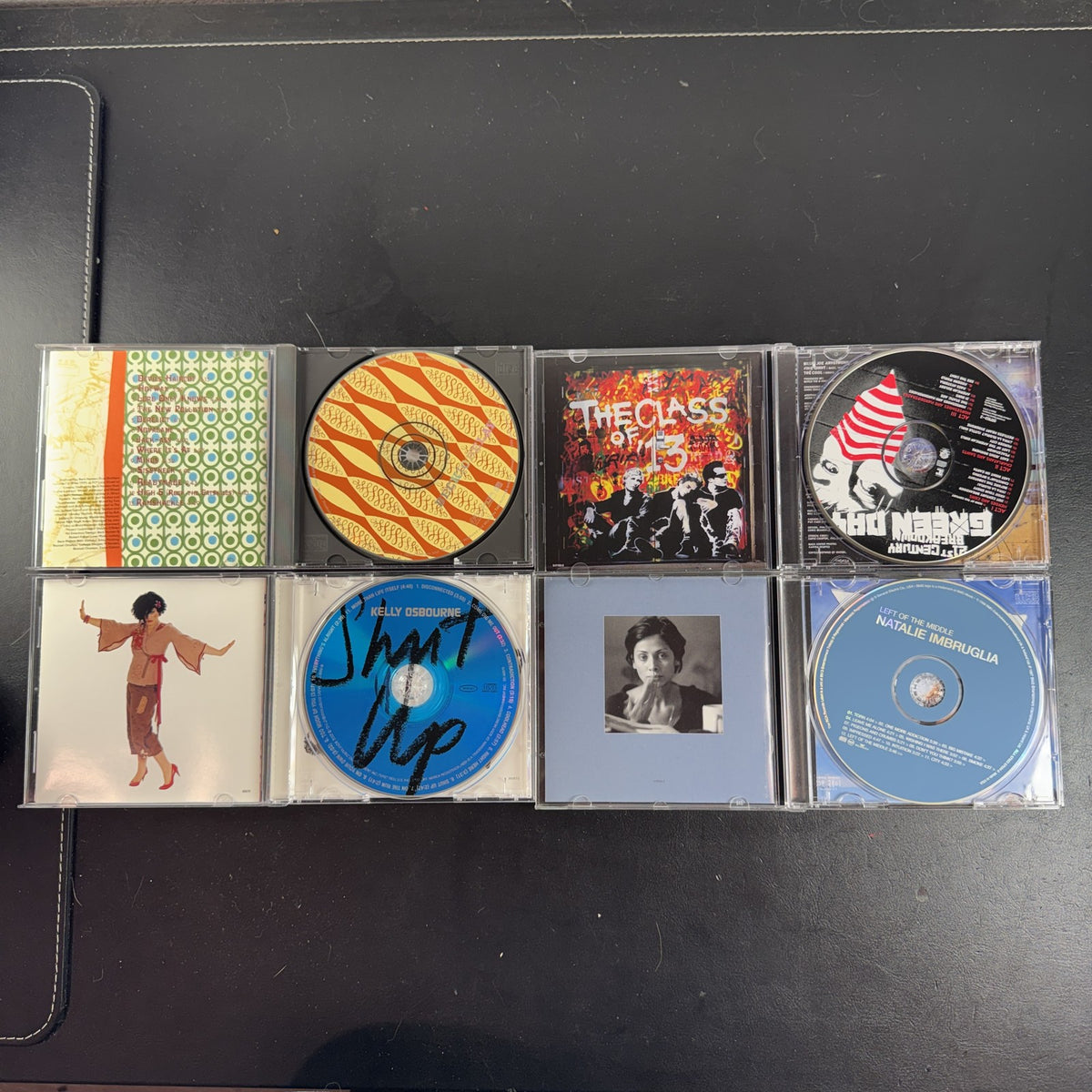 4 CD album lot featuring Beck Odelay, Green Day 21st Century Breakdown, Natalie Imbruglia, and Kelly Osbourne CDs