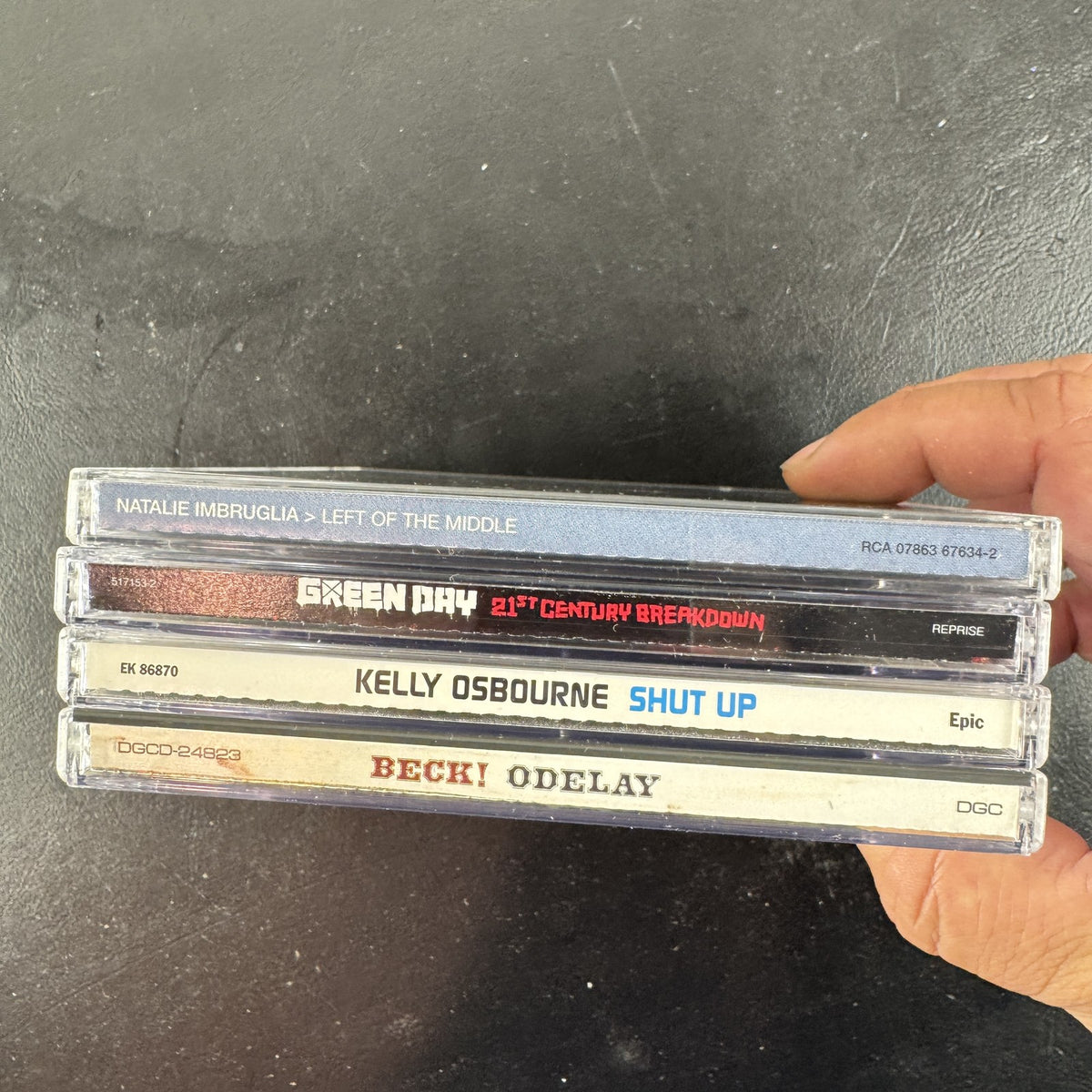 4 CD album lot featuring Beck Odelay, Green Day 21st Century Breakdown, Natalie Imbruglia, and Kelly Osbourne CDs