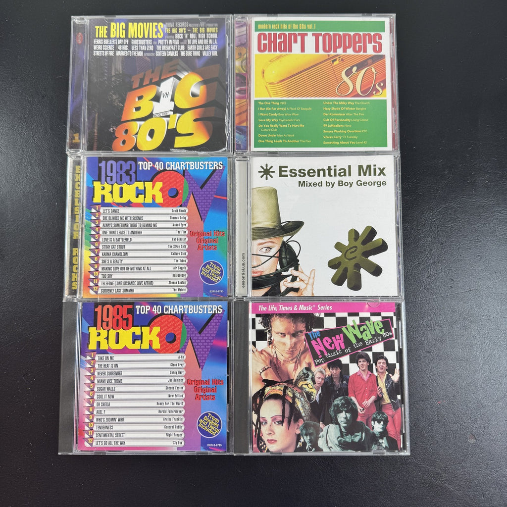 Set of 6 pre-owned 1980s compilation CDs including 80s movie hits and new wave rock collections.