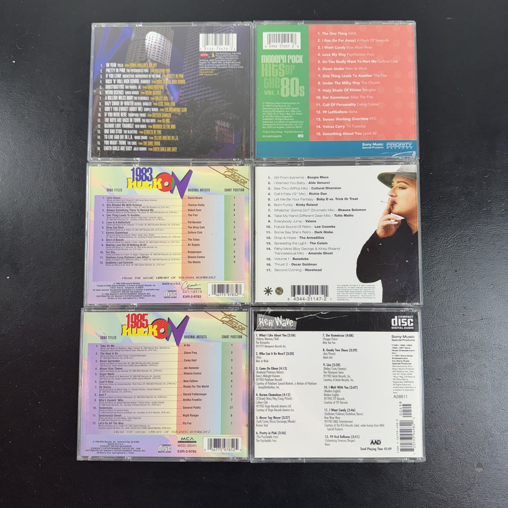 Set of 6 pre-owned 1980s compilation CDs including 80s movie hits and new wave rock collections.