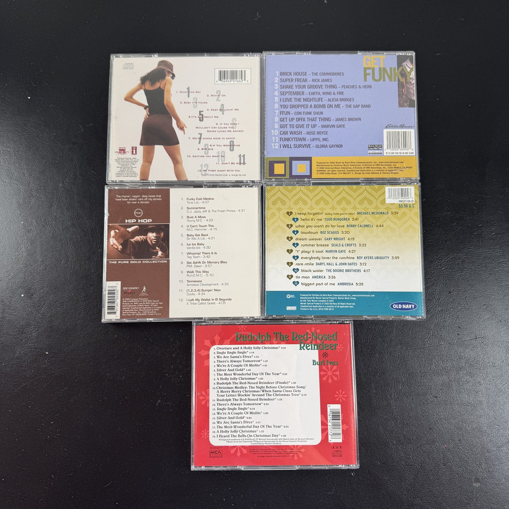 Set of 5 pre-owned music CDs including Mýa album, Burl Ives Rudolph, and 70s compilation albums.