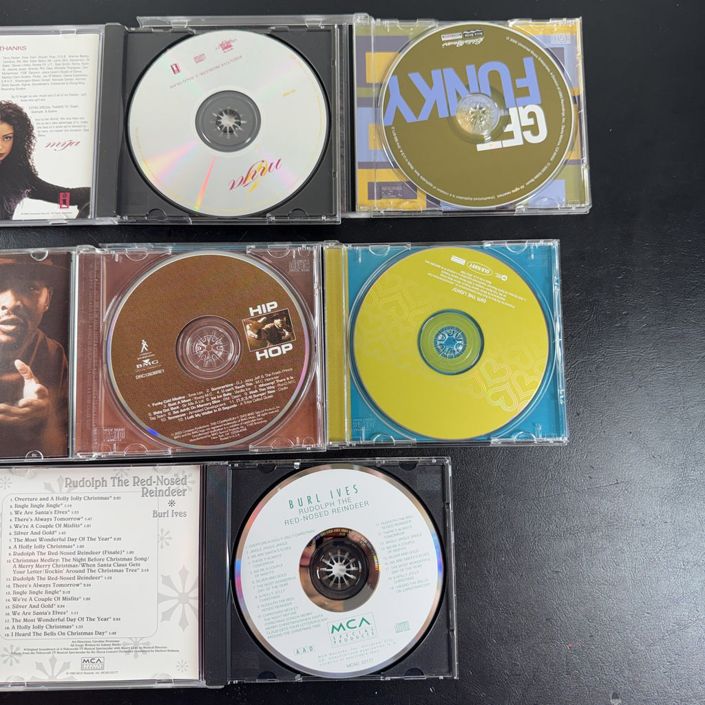 Set of 5 pre-owned music CDs including Mýa album, Burl Ives Rudolph, and 70s compilation albums.
