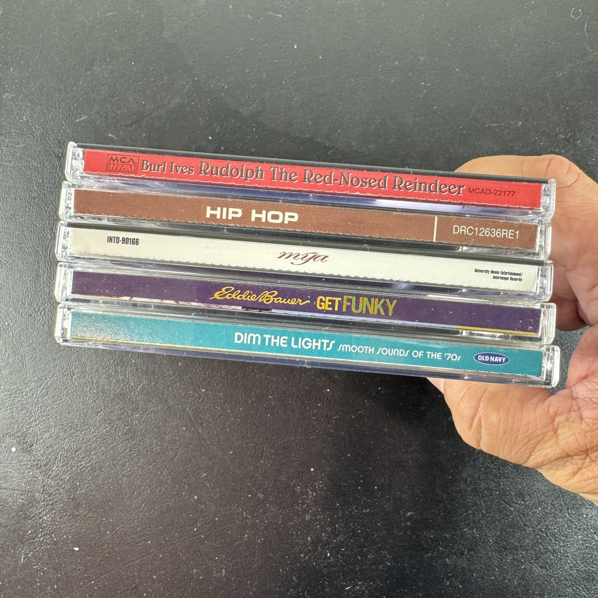 Set of 5 pre-owned music CDs including Mýa album, Burl Ives Rudolph, and 70s compilation albums.