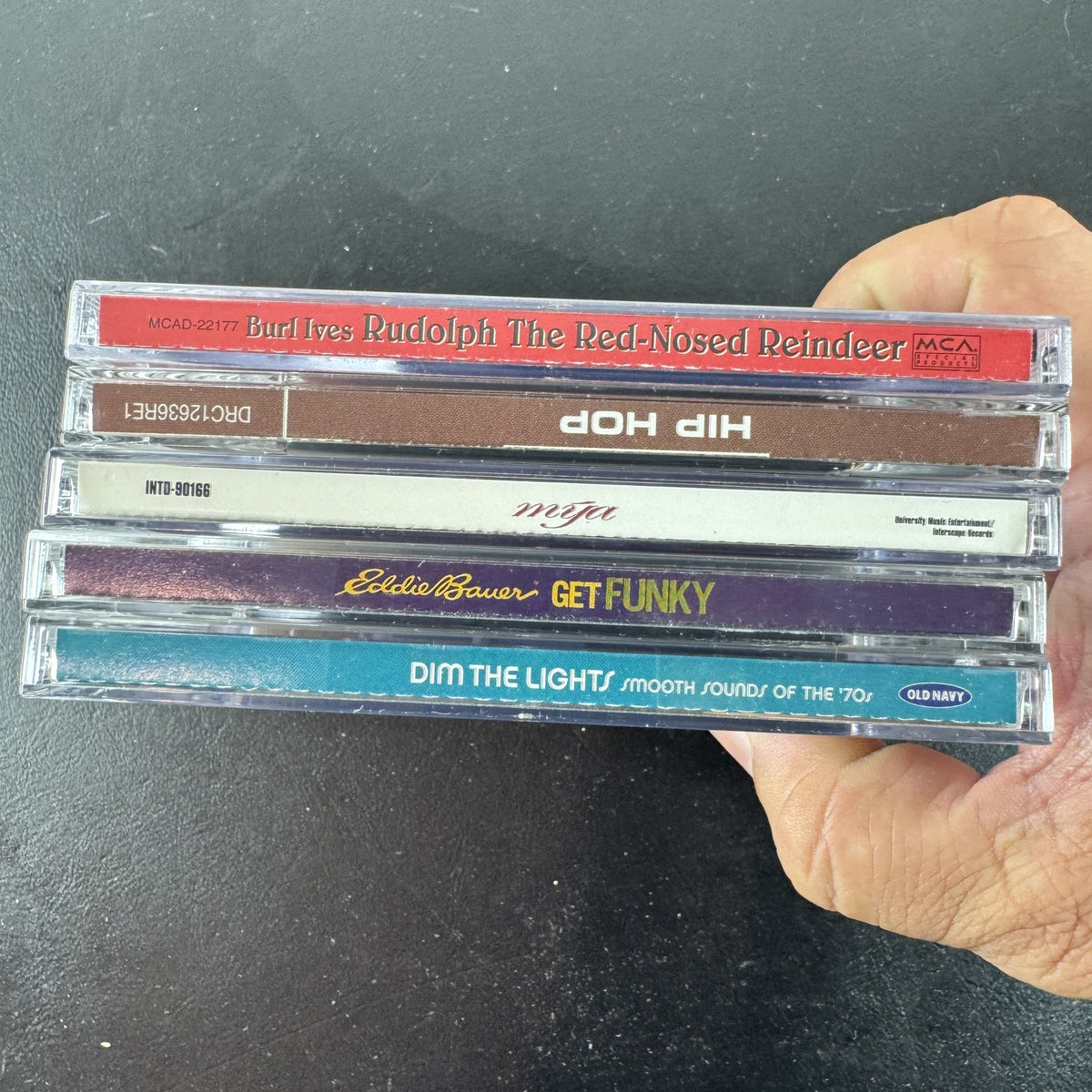 Set of 5 pre-owned music CDs including Mýa album, Burl Ives Rudolph, and 70s compilation albums.
