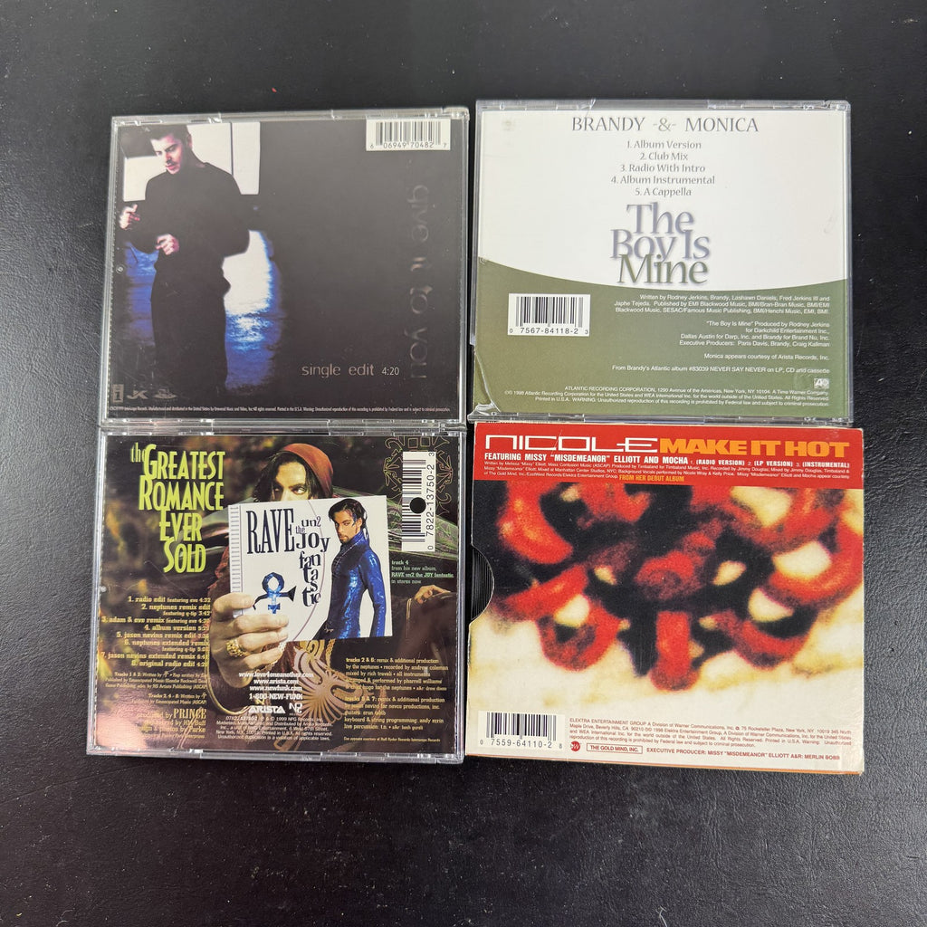 Lot of four late 90s R&B and pop CD singles featuring Brandy and Monica, Prince, Jordan Knight, and Nicole.