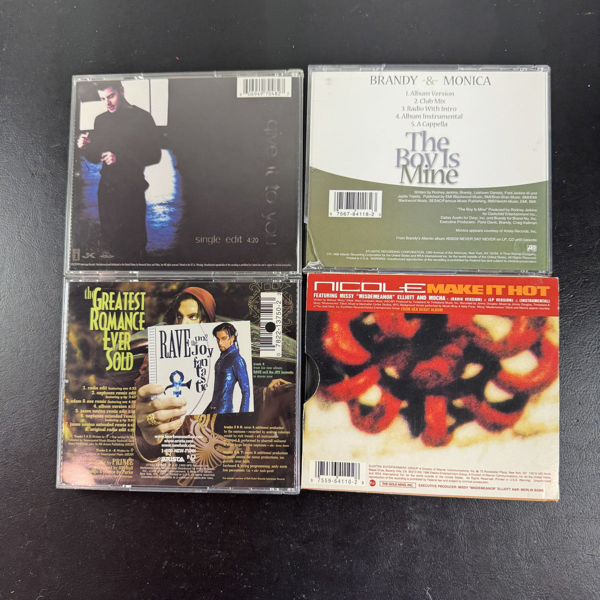 Lot of four late 90s R&B and pop CD singles featuring Brandy and Monica, Prince, Jordan Knight, and Nicole.