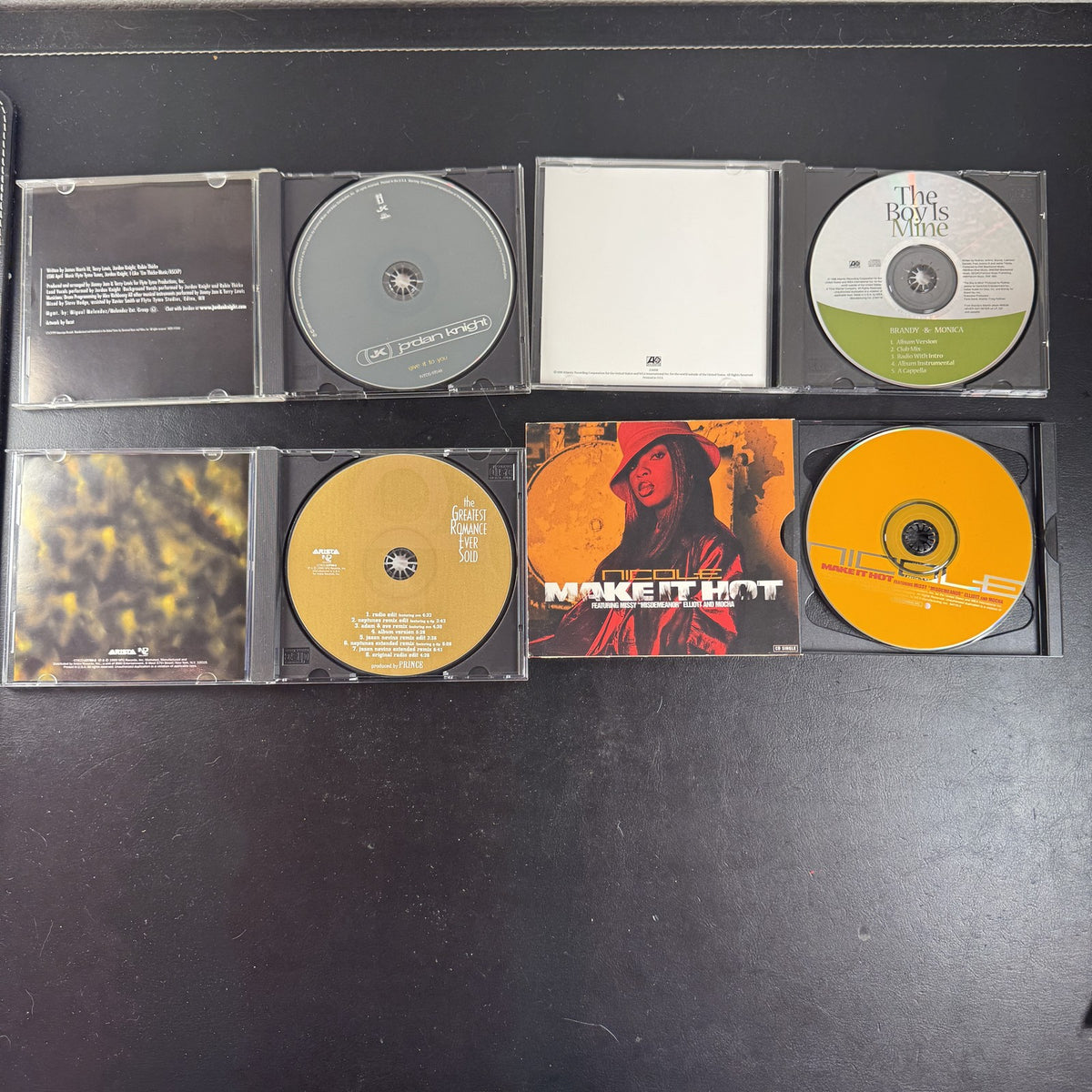 Lot of four late 90s R&B and pop CD singles featuring Brandy and Monica, Prince, Jordan Knight, and Nicole.