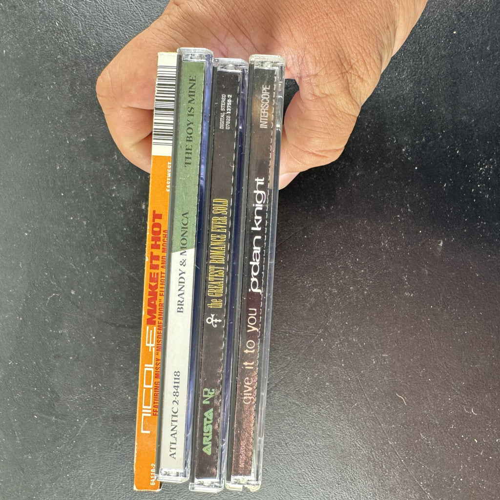Lot of four late 90s R&B and pop CD singles featuring Brandy and Monica, Prince, Jordan Knight, and Nicole.