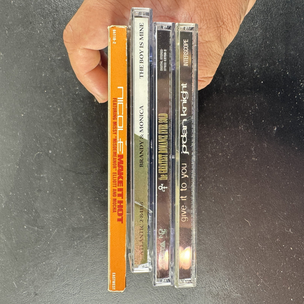 Lot of four late 90s R&B and pop CD singles featuring Brandy and Monica, Prince, Jordan Knight, and Nicole.