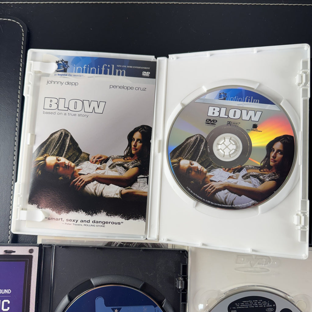 Set of 4 pre-owned DVDs including Blow starring Johnny Depp and Jennifer Lopez movies and music specials.