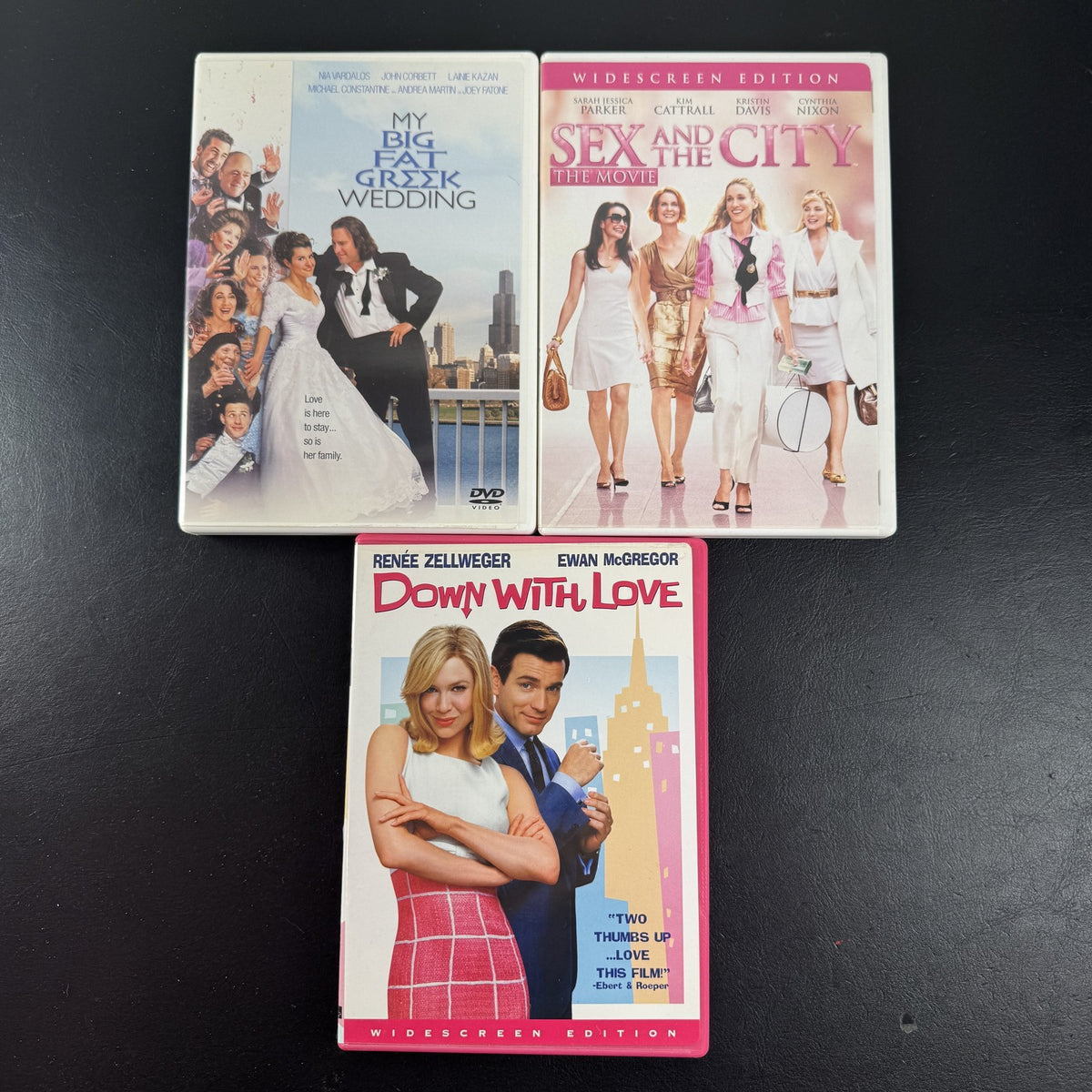 Set of 3 romantic comedy DVDs including Sex and the City, My Big Fat Greek Wedding, and Down with Love.