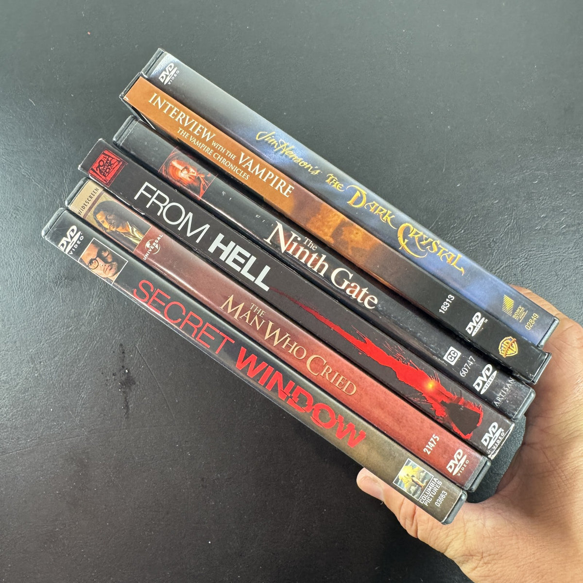 Collection of 6 dark fantasy and thriller DVD cases including The Dark Crystal and Interview with the Vampire