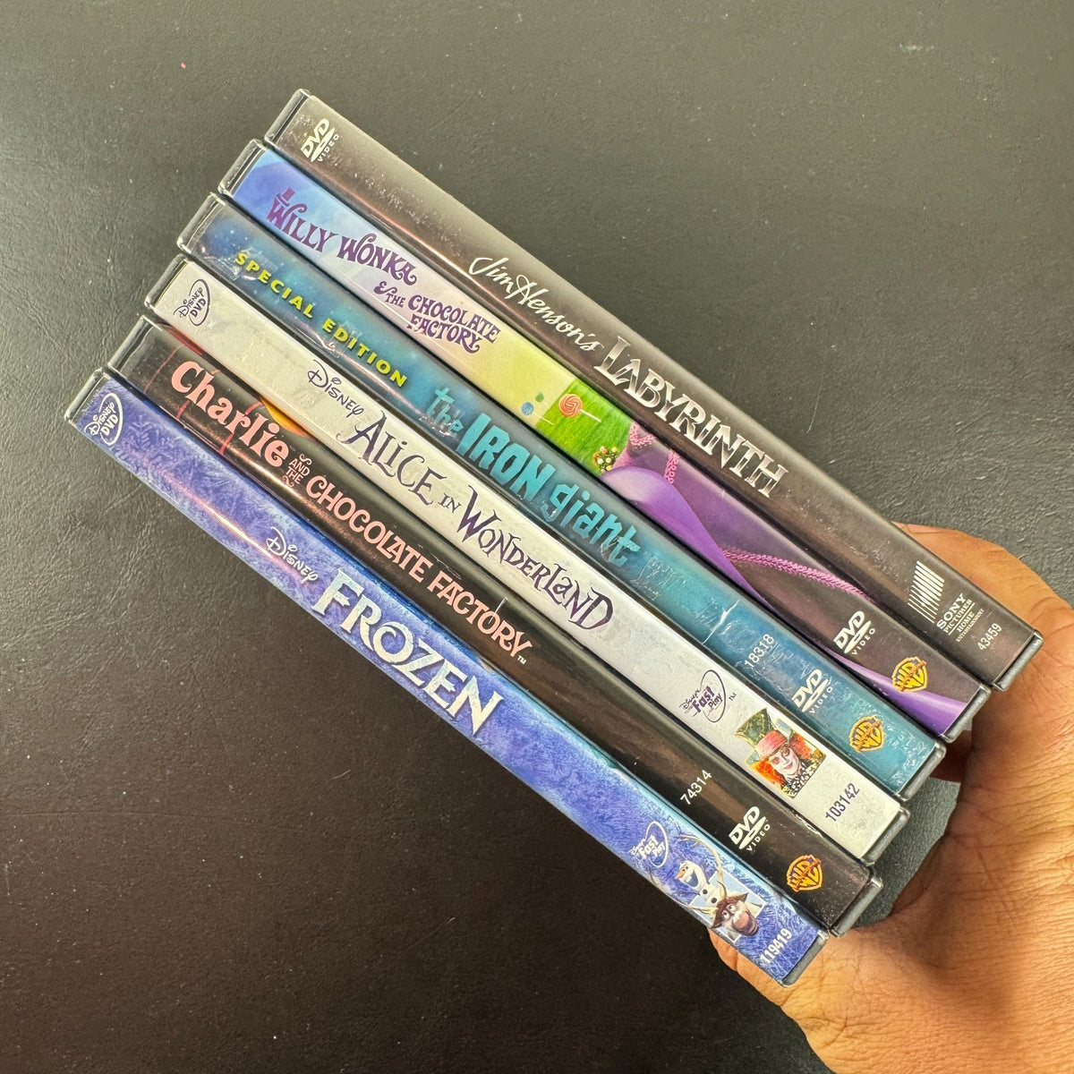Set of 6 pre-owned family fantasy DVDs including Labyrinth, Frozen, The Iron Giant, and Alice in Wonderland