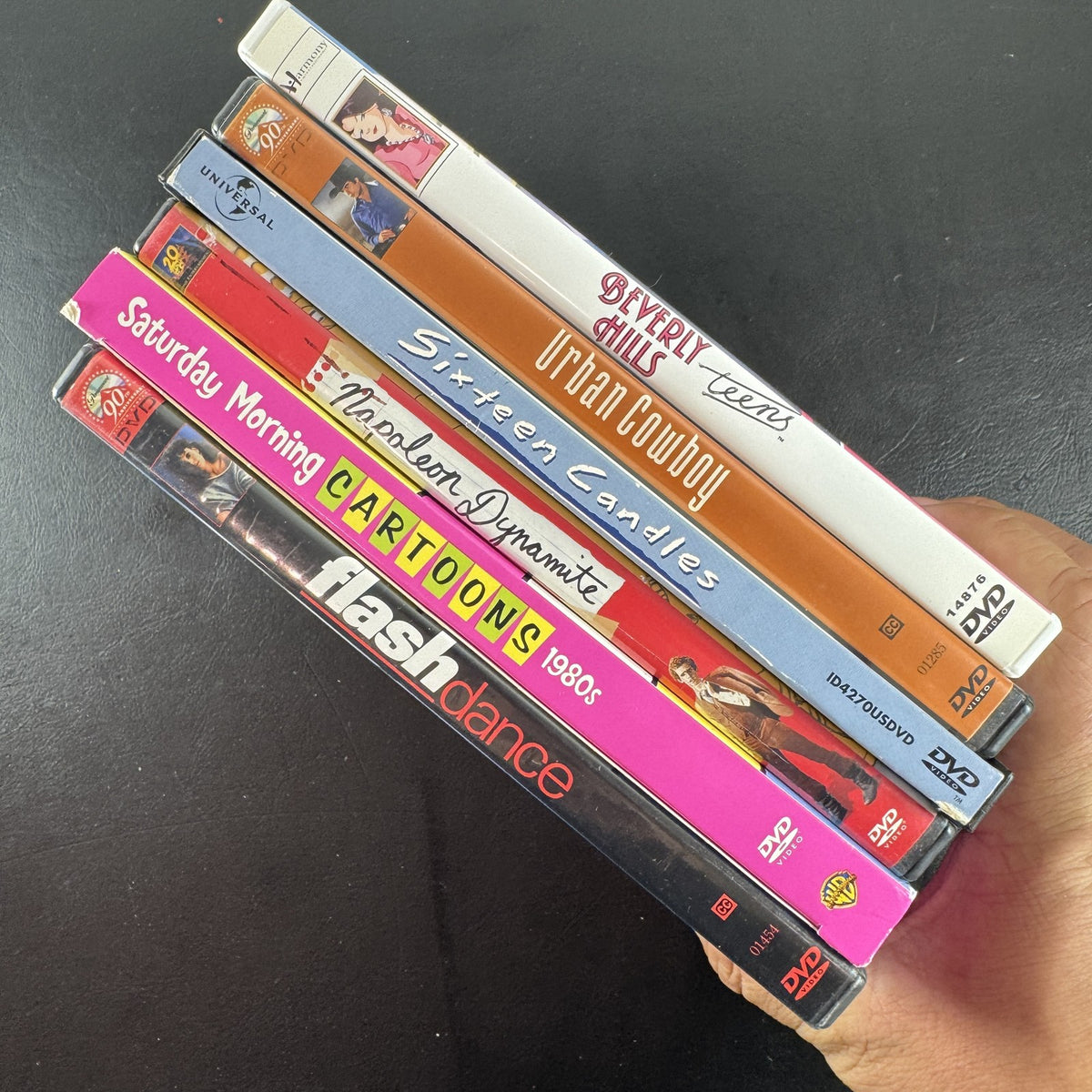 6-DVD movie lot including Sixteen Candles, Flashdance, Urban Cowboy, and Napoleon Dynamite