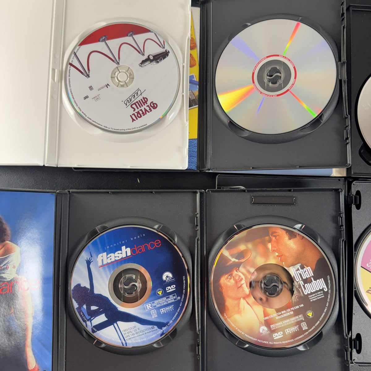 6-DVD movie lot including Sixteen Candles, Flashdance, Urban Cowboy, and Napoleon Dynamite