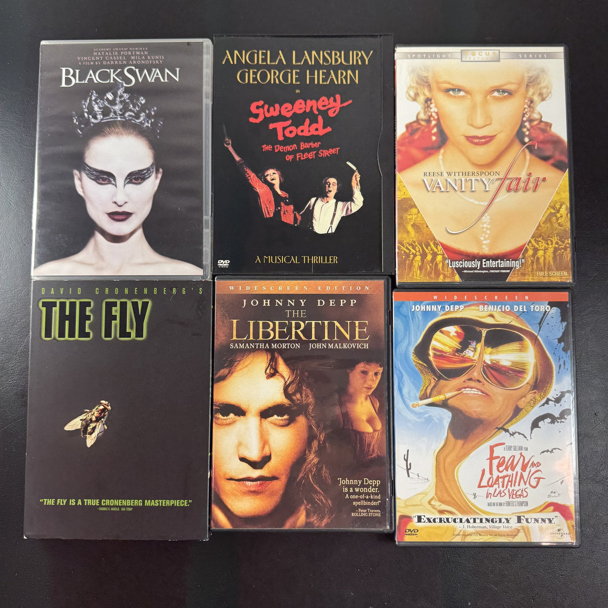 Set of 6 pre-owned DVD movie cases including Black Swan, David Cronenberg's The Fly, and Fear and Loathing in Las Vegas.