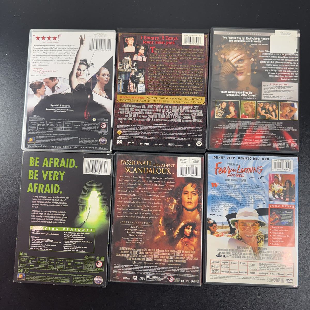 Set of 6 pre-owned DVD movie cases including Black Swan, David Cronenberg's The Fly, and Fear and Loathing in Las Vegas.
